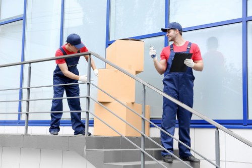 Local movers carrying furniture through a Knightsbridge property
